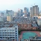 Classroom View of Kunming  This is the view of Kunming from my classroom window. It seems that the whole city is being heavily developed as - all over the city and wherever you are or look -  there are massive construction sites for new subway lines, shopping malls and office buildings.